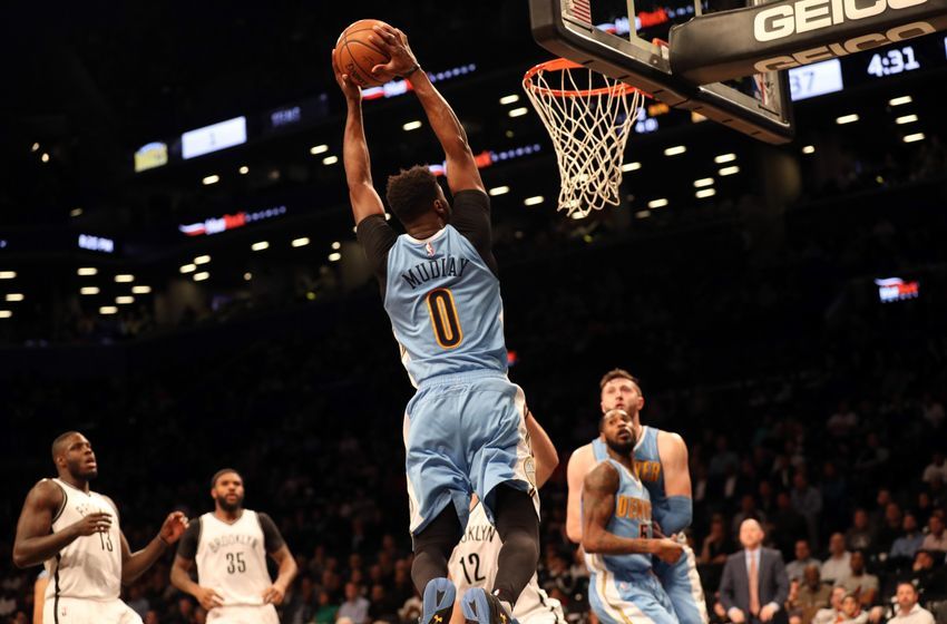 Dec 7, 2016; Brooklyn, NY, USA; Denver Nuggets guard Emmanuel Mudiay (0) reaches for the net during the second quarter against the Brooklyn Nets at Barclays Center. Mandatory Credit: Anthony Gruppuso-USA TODAY Sports