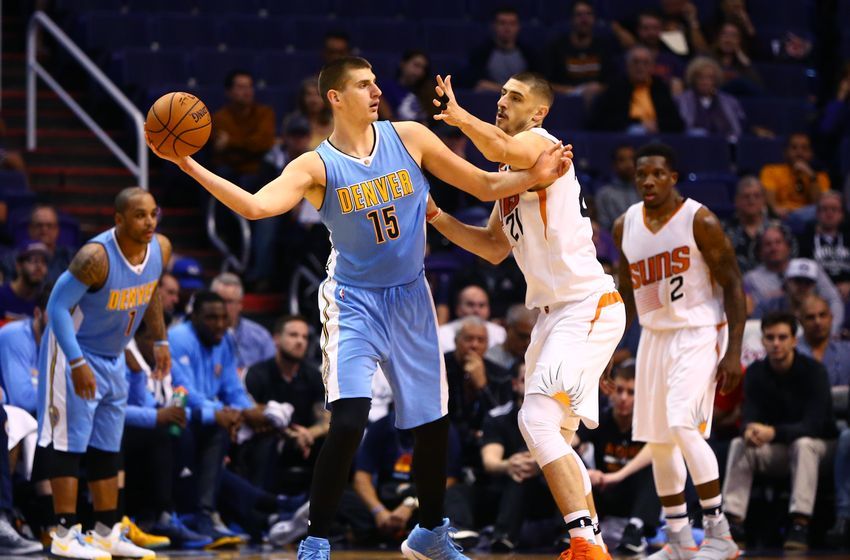 Nov 27, 2016; Phoenix, AZ, USA; Denver Nuggets forward Nikola Jokic (15) controls the ball against Phoenix Suns center Alex Len (21) at Talking Stick Resort Arena. The Nuggets defeated the Suns 118-114. Mandatory Credit: Mark J. Rebilas-USA TODAY Sports