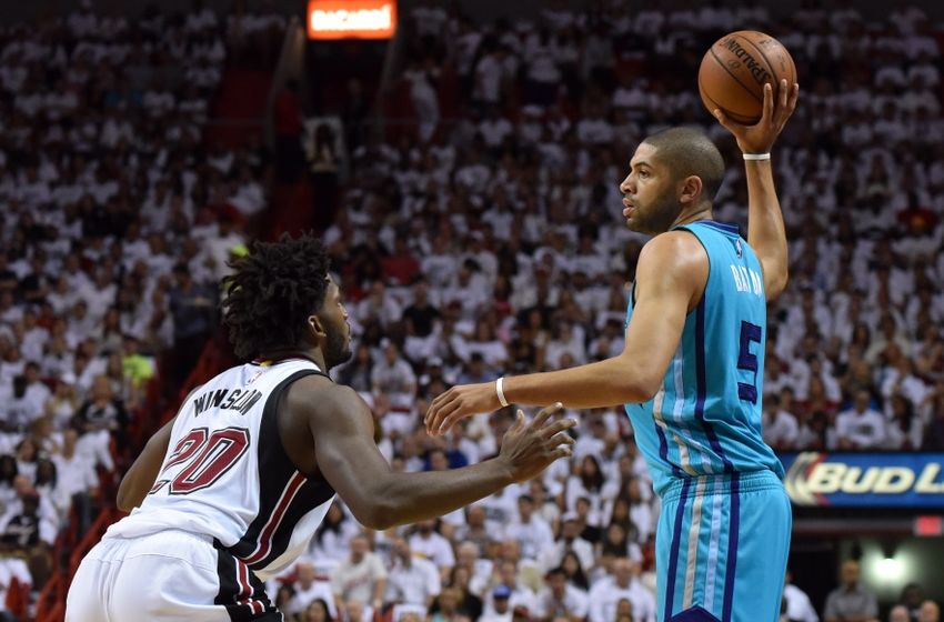 Apr 17, 2016; Miami, FL, USA; Charlotte Hornets guard Nicolas Batum (5) looks to pass the ball as Miami Heat forward Justise Winslow (20) defends during the first half in game one of the first round of the NBA Playoffs at American Airlines Arena. Mandatory Credit: Steve Mitchell-USA TODAY Sports