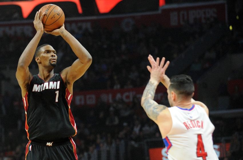 January 13, 2016; Los Angeles, CA, USA; Miami Heat forward Chris Bosh (1) shoots against the defense of Los Angeles Clippers guard J.J. Redick (4) during the first half at Staples Center. Mandatory Credit: Gary A. Vasquez-USA TODAY Sports