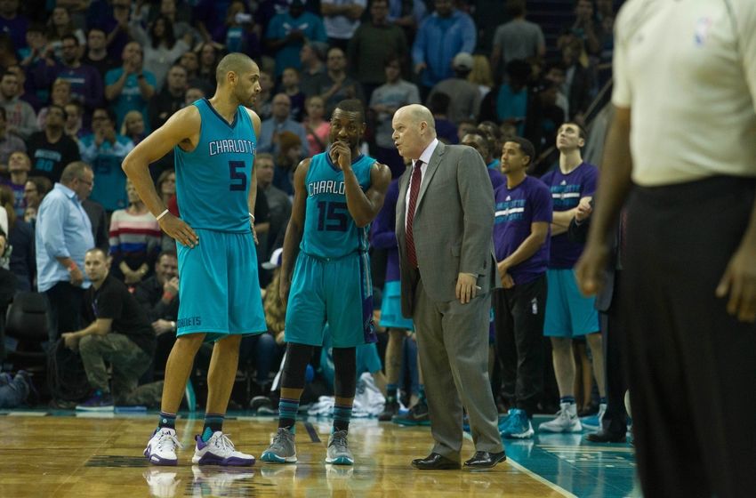 Dec 26, 2015; Charlotte, NC, USA; Charlotte Hornets head coach Steve Clifford talks with guard Nicolas Batum (5) and guard Kemba Walker (15) during the second half against the Memphis Grizzlies at Time Warner Cable Arena. The Hornets defeated the Grizzlies 98-92. Mandatory Credit: Jeremy Brevard-USA TODAY Sports