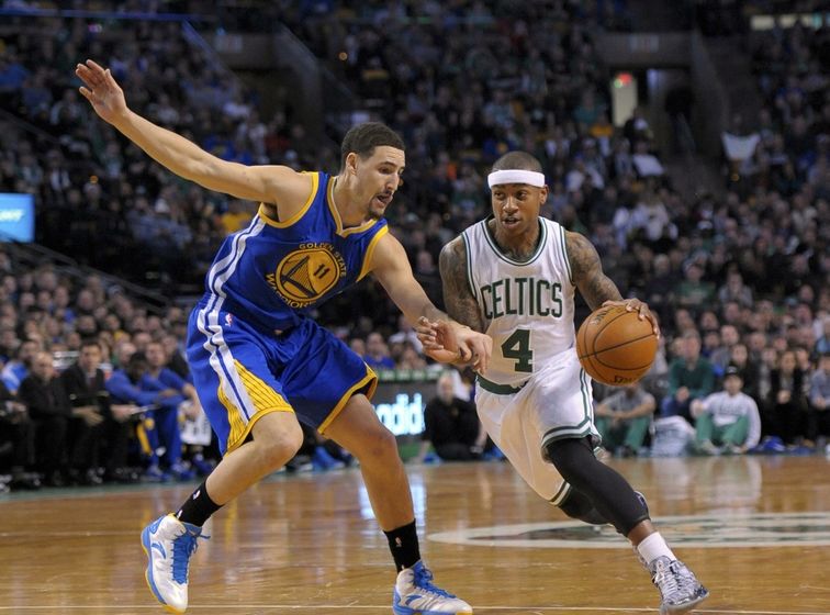 Mar 1, 2015; Boston, MA, USA; Boston Celtics guard Isaiah Thomas (4) controls the ball while being defended by Golden State Warriors guard Klay Thompson (11) during the first half at TD Garden. Mandatory Credit: Bob DeChiara-USA TODAY Sports