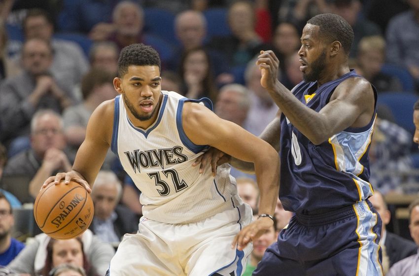 Nov 1, 2016; Minneapolis, MN, USA; Minnesota Timberwolves forward Karl-Anthony Towns (32) dribbles the ball as Memphis Grizzlies forward JaMychal Green (0) plays defense in the first half at Target Center. Mandatory Credit: Jesse Johnson-USA TODAY Sports