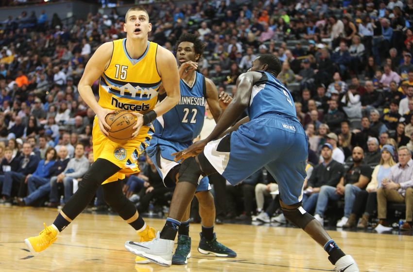 Dec 28, 2016; Denver, CO, USA; Denver Nuggets forward Nikola Jokic (15) spins towards the basket against Minnesota Timberwolves forward Gorgui Dieng (5) during the first half at Pepsi Center. Mandatory Credit: Chris Humphreys-USA TODAY Sports