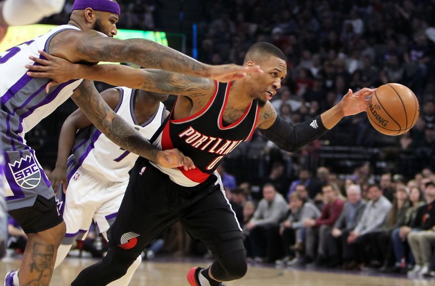 Dec 20, 2016; Sacramento, CA, USA; Portland Trail Blazers guard Damian Lillard (0) drives past Sacramento Kings forward DeMarcus Cousins (15) during the first quarter at Golden 1 Center. Mandatory Credit: Sergio Estrada-USA TODAY Sports