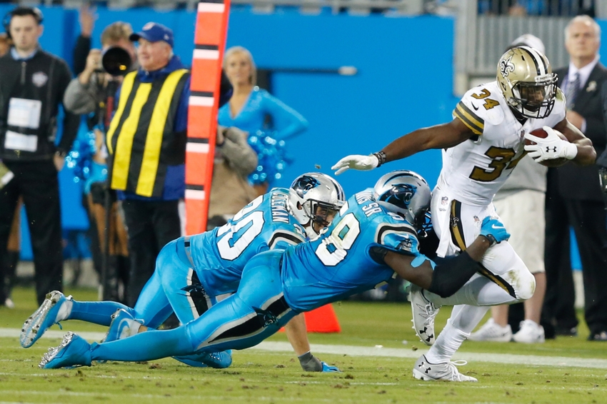 Nov 17, 2016; Charlotte, NC, USA; New Orleans Saints running back Tim Hightower (34) gets tackled by Carolina Panthers outside linebacker Thomas Davis (58) in the fourth quarter at Bank of America Stadium. The Panthers defeated the Saints 23-20. Mandatory Credit: Jeremy Brevard-USA TODAY Sports