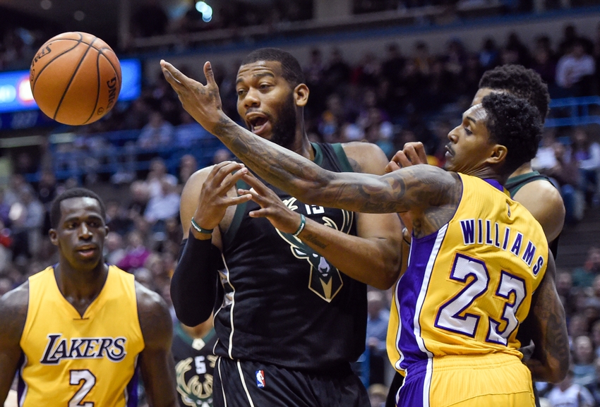 Feb 22, 2016; Milwaukee, WI, USA; Milwaukee Bucks center Greg Monroe (15) and Los Angeles Lakers guard Louis Williams (23) battle for a loose ball in the fourth quarter at BMO Harris Bradley Center. The Bucks beat the Lakers 108-101. Mandatory Credit: Benny Sieu-USA TODAY Sports