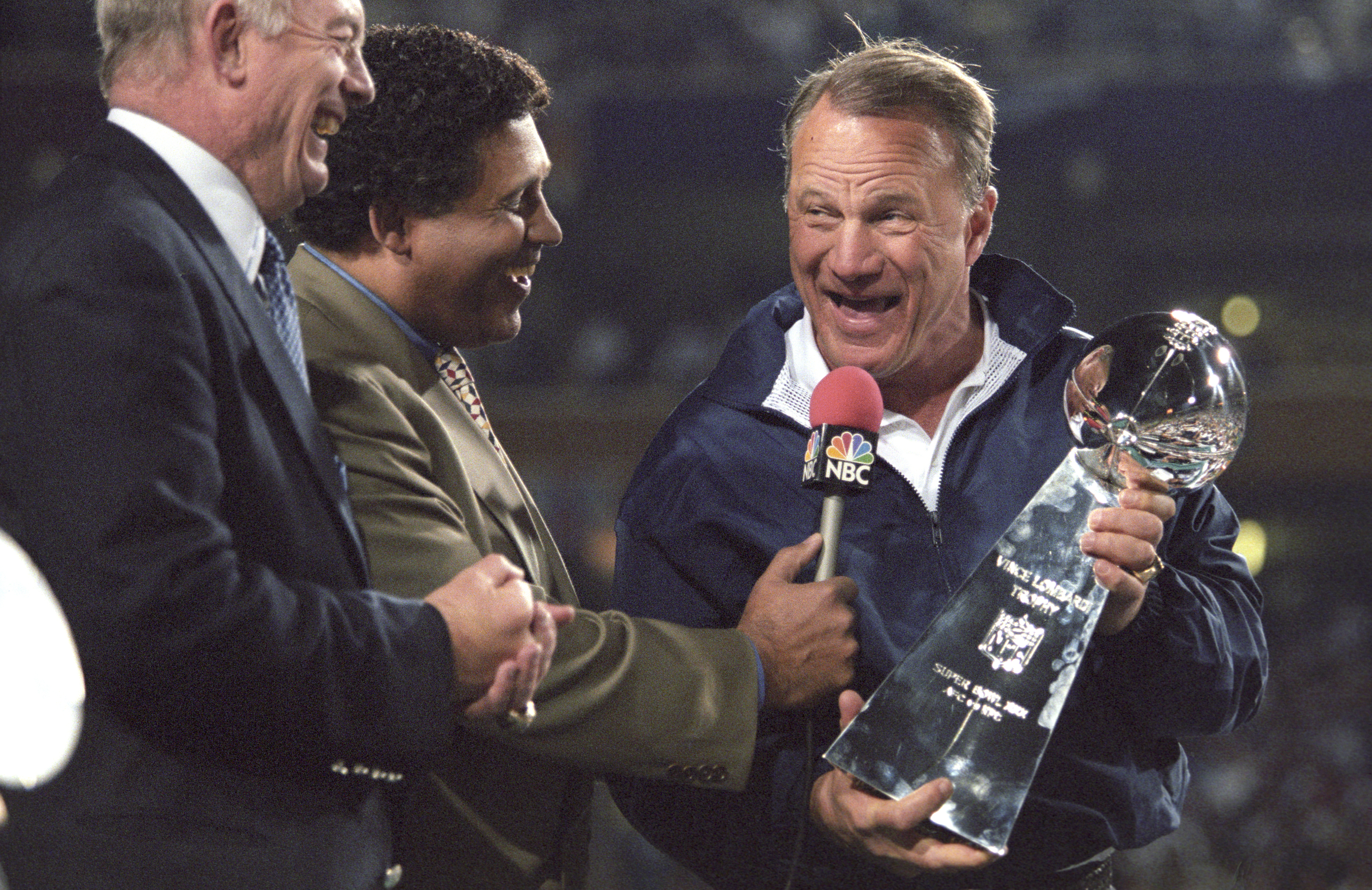 Football: Super Bowl XXX: Dallas Cowboys coach Barry Switzer victorious holding Vince Lombardi Trophy with NBC Sports announcer Greg Gumbel (C) and Cowboys owner Jerry Jones after winning game vs Pittsburgh Steelers at Sun Devil Stadium.Tempe, AZ 1/28/1996CREDIT: Al Tielemans (Photo by Al Tielemans /Sports Illustrated/Getty Images)(Set Number: X50011 TK4 R10 F26 )