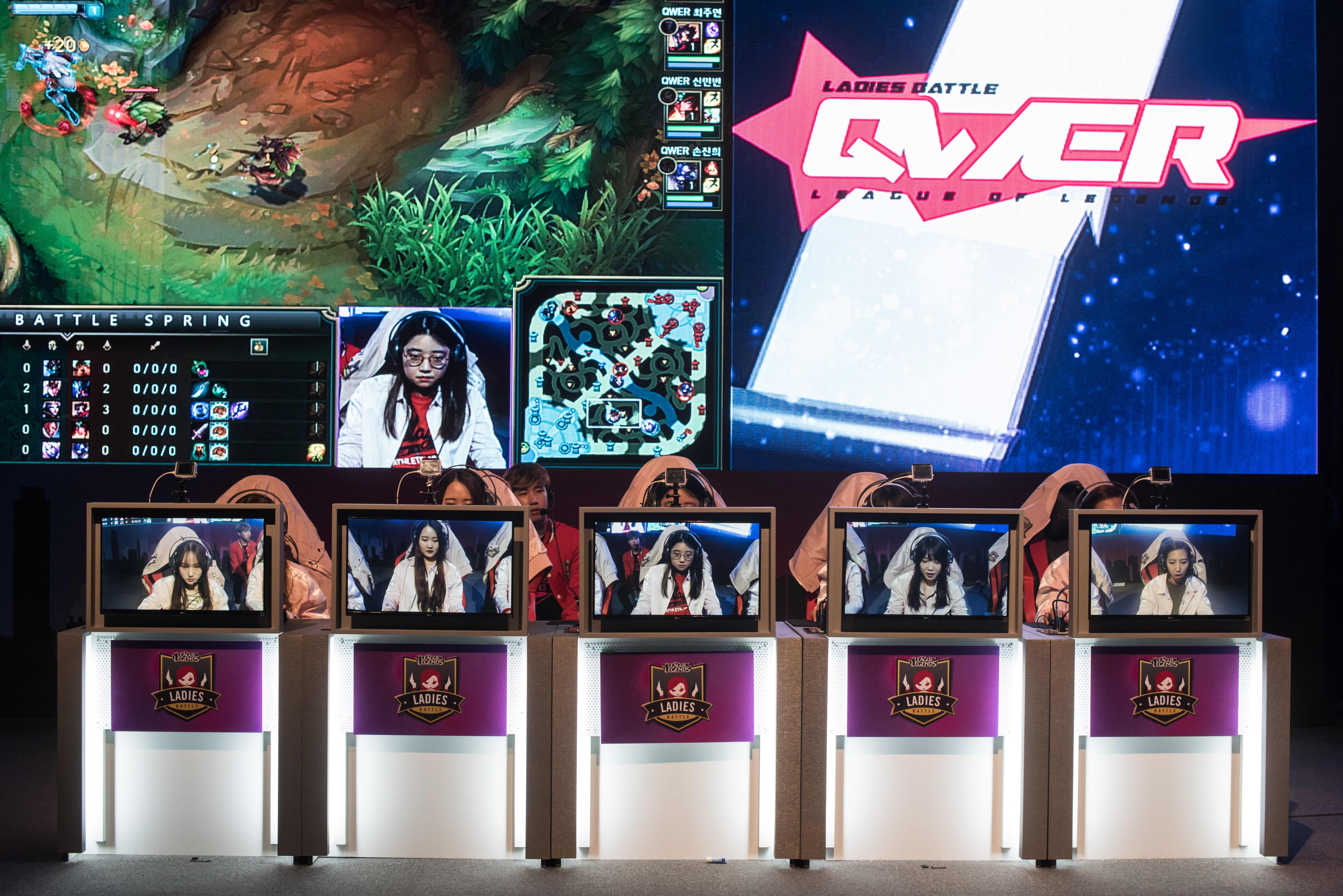 L-R: In a photo taken on April 12, 2016 members of the all-female computer gaming team 'QWER' Ji-Hee Lee (19), Yoo-Jung Lee (22), Ju-Yeon Choi (22), Min-Bin Shin (21), and Jin-Hee Sohn (24) compete in the 'Ladies Battle' League of Legends competition in Seoul. Brought together by a Seoul-based startup, the team trained intesively for a week prior to competing in the 'Ladies Battle, an all-female League of Legends competition. In keeping with a format used by most proffessional male teams, the members of 'QWER' lived together during the training period which involved playing the game for hours on end followed by lengthy review sessions with freelance mentors and former League of Legends champions. Despite South Korea's top-tier gaming credentials proffessional female teams are a minority. But for those who excel at the strategy-based, multi-player game, international competitions can lead to high cash rewards, and the chance to sign on with prominent foreign teams. Internet-based competitive gaming, or e-sports, in South Korea is widespread, with professional teams often attracting sponsorship from the country's largest tech companies. The country has long promoted its internet technology as a key driver of growth; with Seoul often referred to as the 'most wired' city on the planet. / AFP / ED JONES (Photo credit should read ED JONES/AFP/Getty Images)