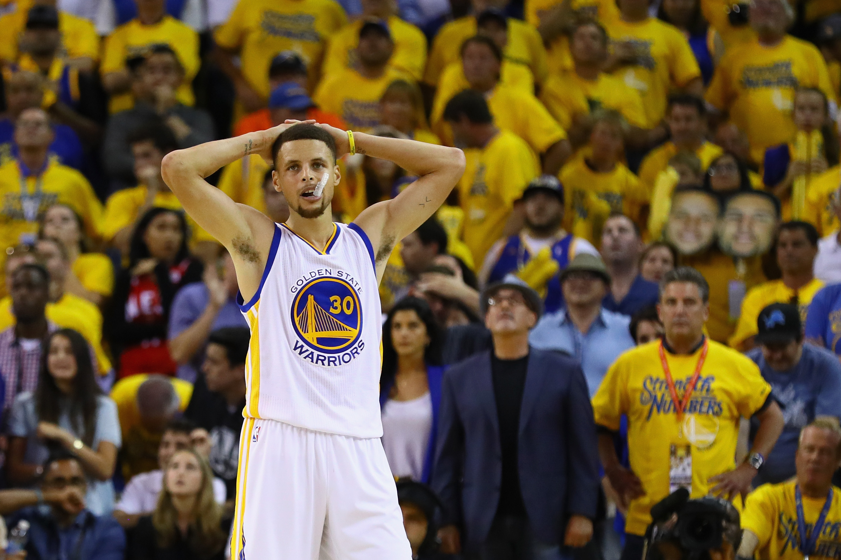 Video: Stephen Curry hits half court shot while sitting down