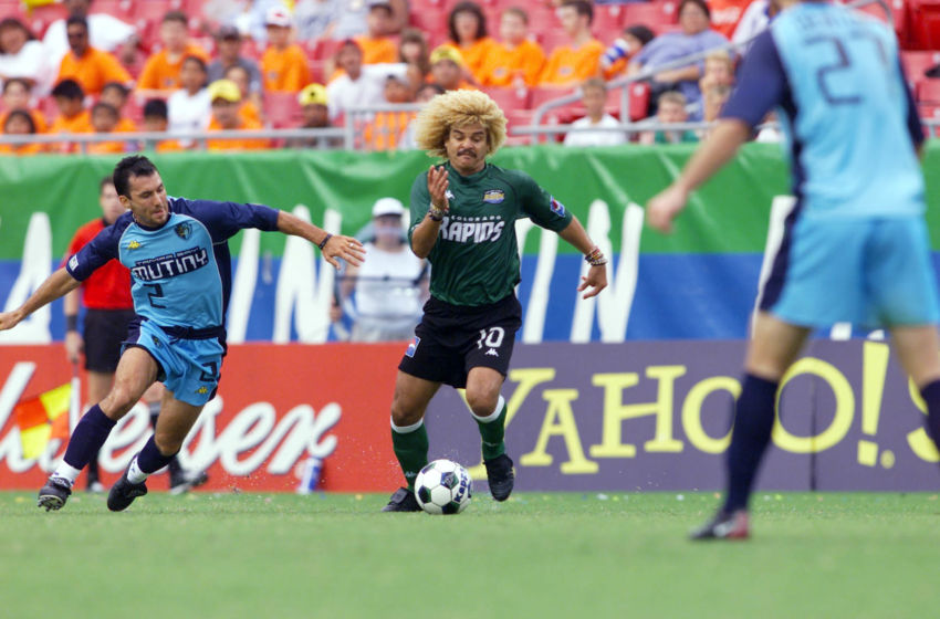 21 Jul 2001: Carlos Valderrama #10 of the Colorado Rapids dribbles against the defense of the Tampa Bay Mutiny at Raymond James Stadium in Tampa, Florida. The Rapids won 2-1 over the Mutiny. DIGITAL IMAGE. Mandatory Credit: Andy Lyons/ALLSPORT