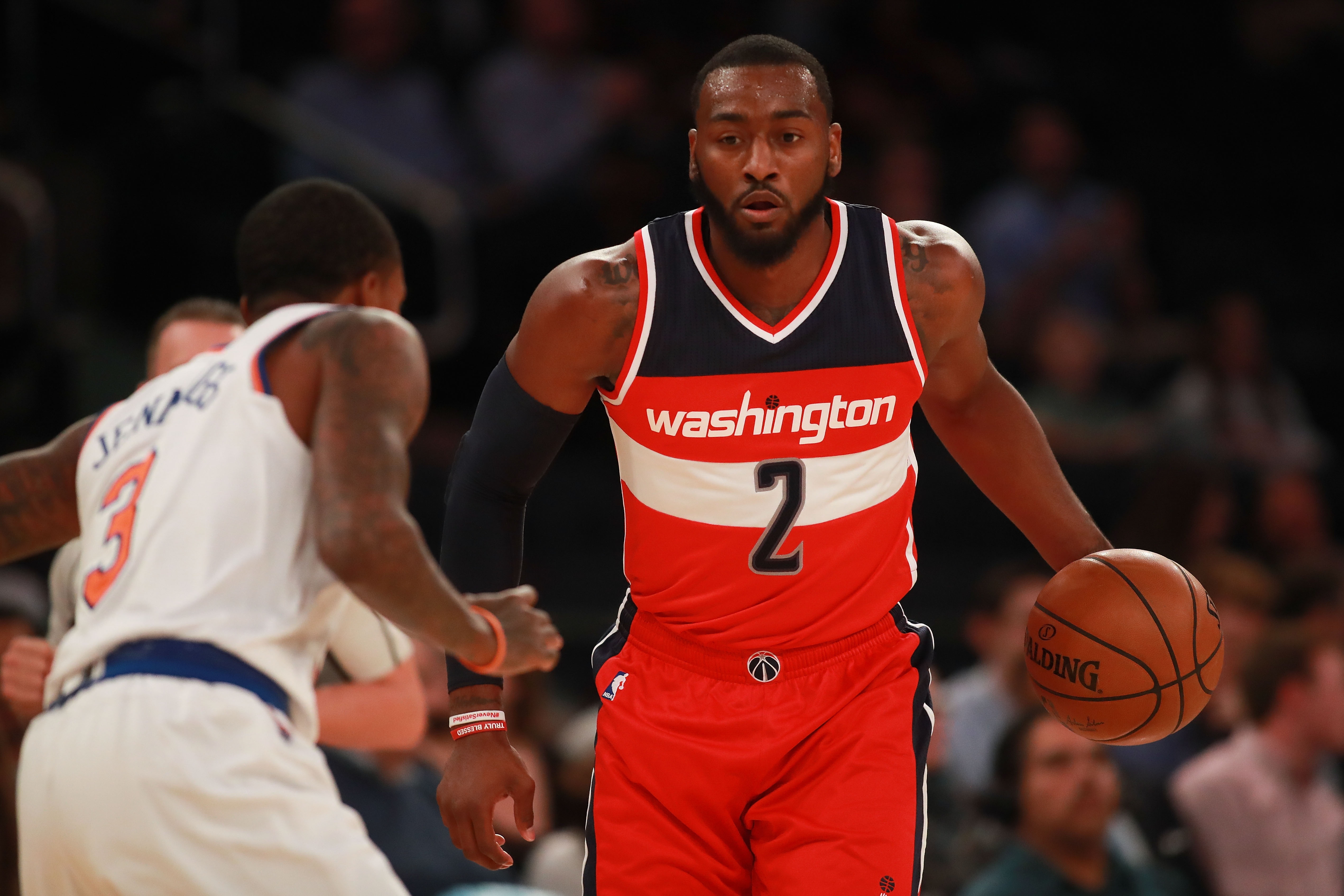NEW YORK, NY - OCTOBER 10: John Wall #2 of the Washington Wizards dribbles up court against Brandon Jennings #3 of the New York Knicks in the first half of the preseason game at Madison Square Garden on October 10, 2016 in New York City. NOTE TO USER: User expressly acknowledges and agrees that, by downloading and or using this photograph, User is consenting to the terms and conditions of the Getty Images License Agreement. (Photo by Michael Reaves/Getty Images)