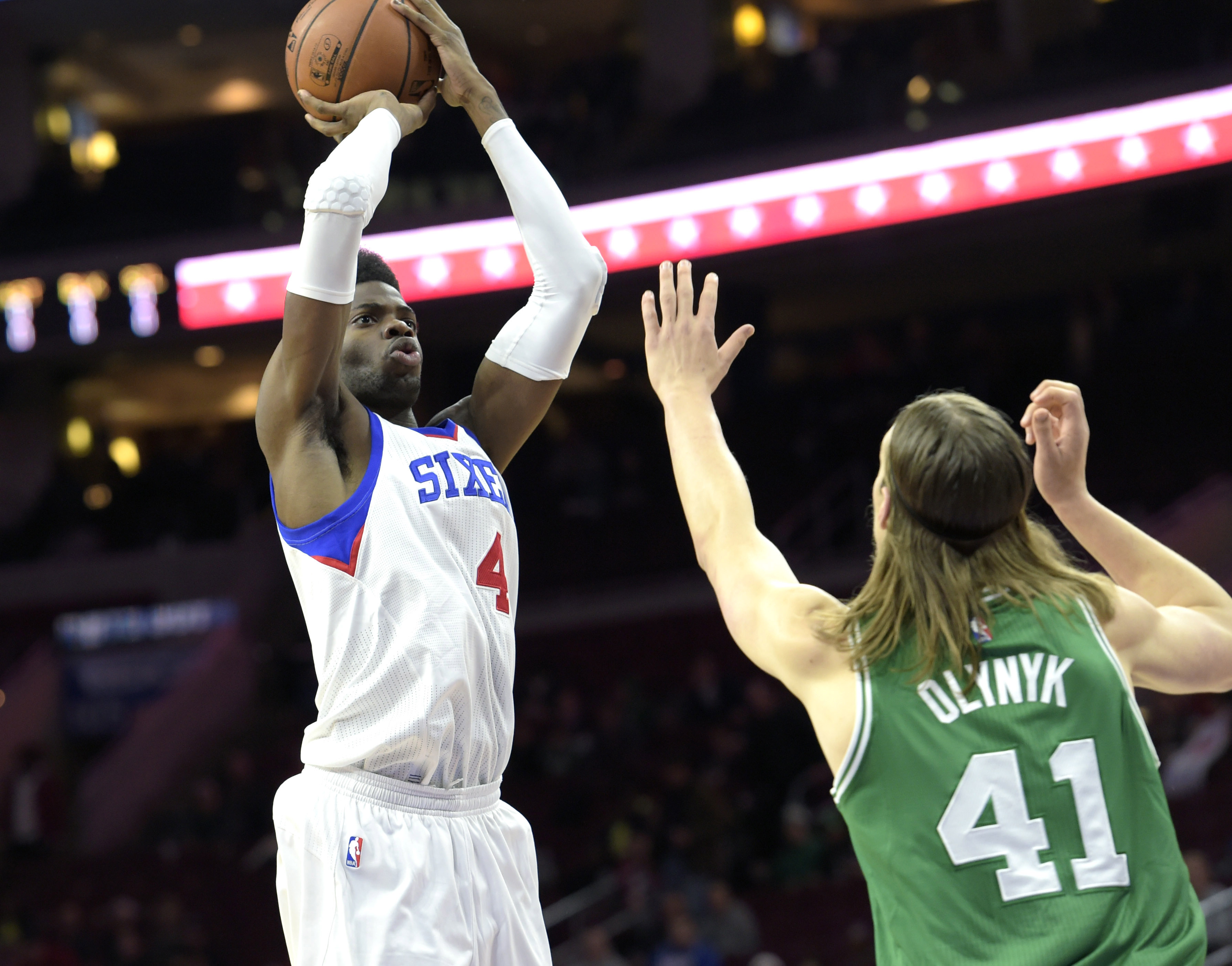 Nov 19, 2014; Philadelphia, PA, USA; Philadelphia 76ers forward Nerlens Noel (4) shoots the ball over Boston Celtics center Kelly Olynyk (41) during the first quarter at Wells Fargo Center. Mandatory Credit: Eric Hartline-USA TODAY Sports