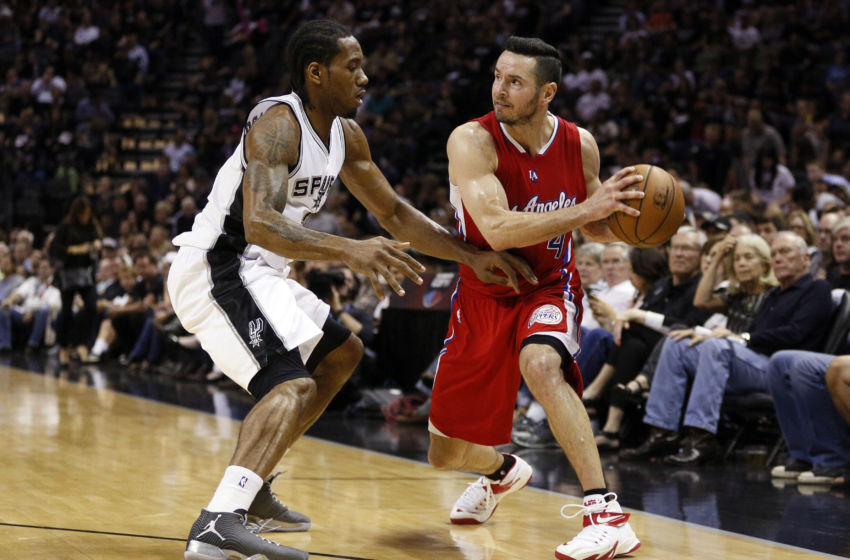 Apr 24, 2015; San Antonio, TX, USA; Los Angeles Clippers shooting guard J.J. Redick (R) looks to pass the ball as San Antonio Spurs small forward Kawhi Leonard (L) defends in game three of the first round of the NBA Playoffs at AT&T Center. Mandatory Credit: Soobum Im-USA TODAY Sports