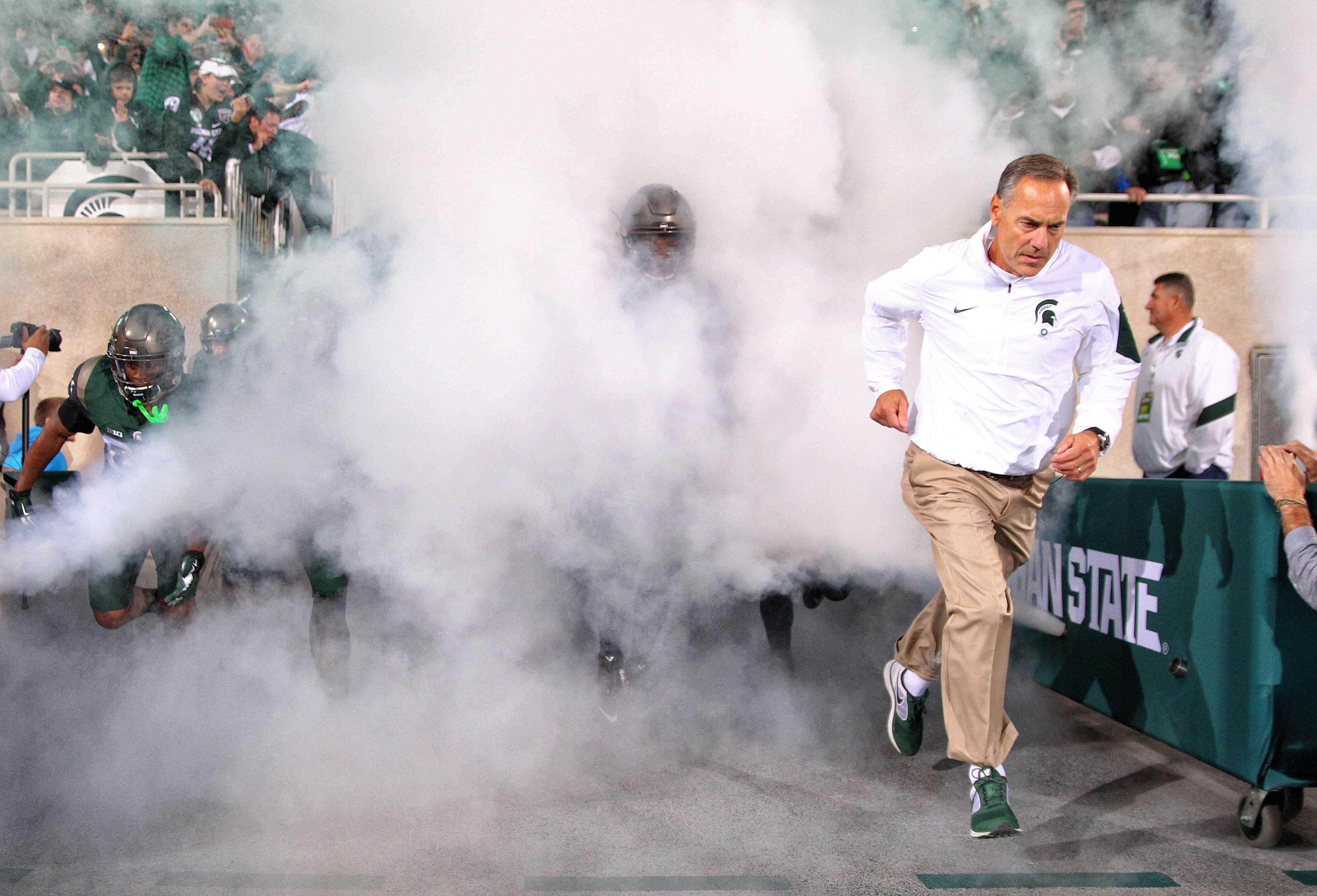 Sep 12, 2015; East Lansing, MI, USA; Michigan State Spartans head coach Mark Dantonio brings his team onto the flied prior to a game at Spartan Stadium. Mandatory Credit: Mike Carter-USA TODAY Sports