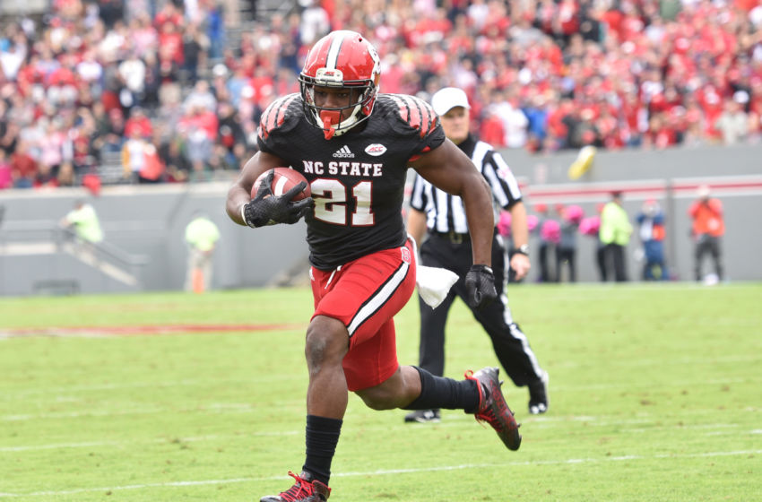 Oct 3, 2015; Raleigh, NC, USA; North Carolina State Wolfpack running back Matthew Dayes (21) scores a touchdown during the second quarter against the Louisville Cardinals at Carter Finley Stadium. Mandatory Credit: Evan Pike-USA TODAY Sports