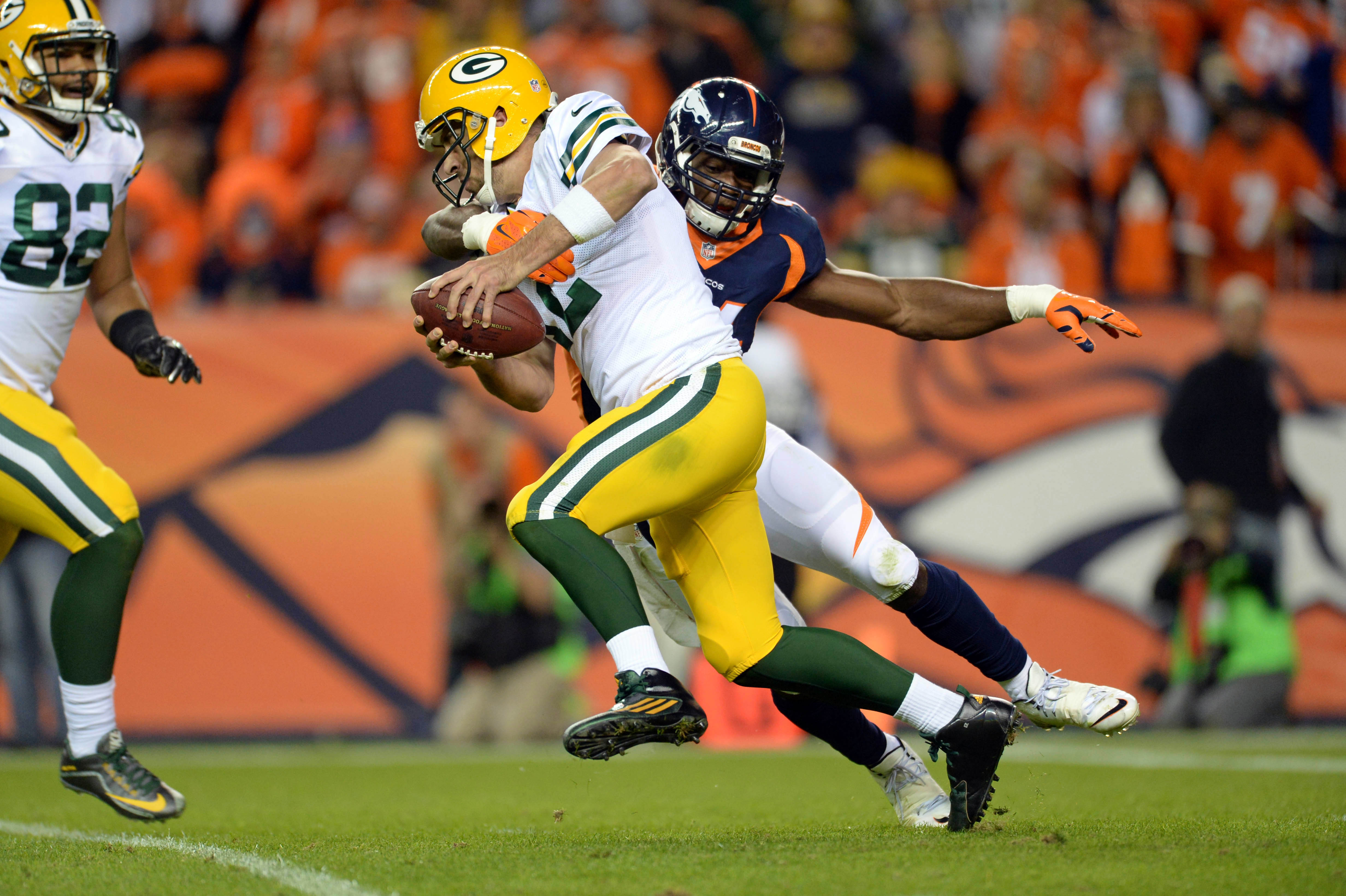 Nov 1, 2015; Denver, CO, USA; Denver Broncos outside linebacker DeMarcus Ware (94) sacks Green Bay Packers quarterback Aaron Rodgers (12) in the fourth quarter at Sports Authority Field at Mile High. The Broncos defeated the Packer 29-10. Mandatory Credit: Ron Chenoy-USA TODAY Sports