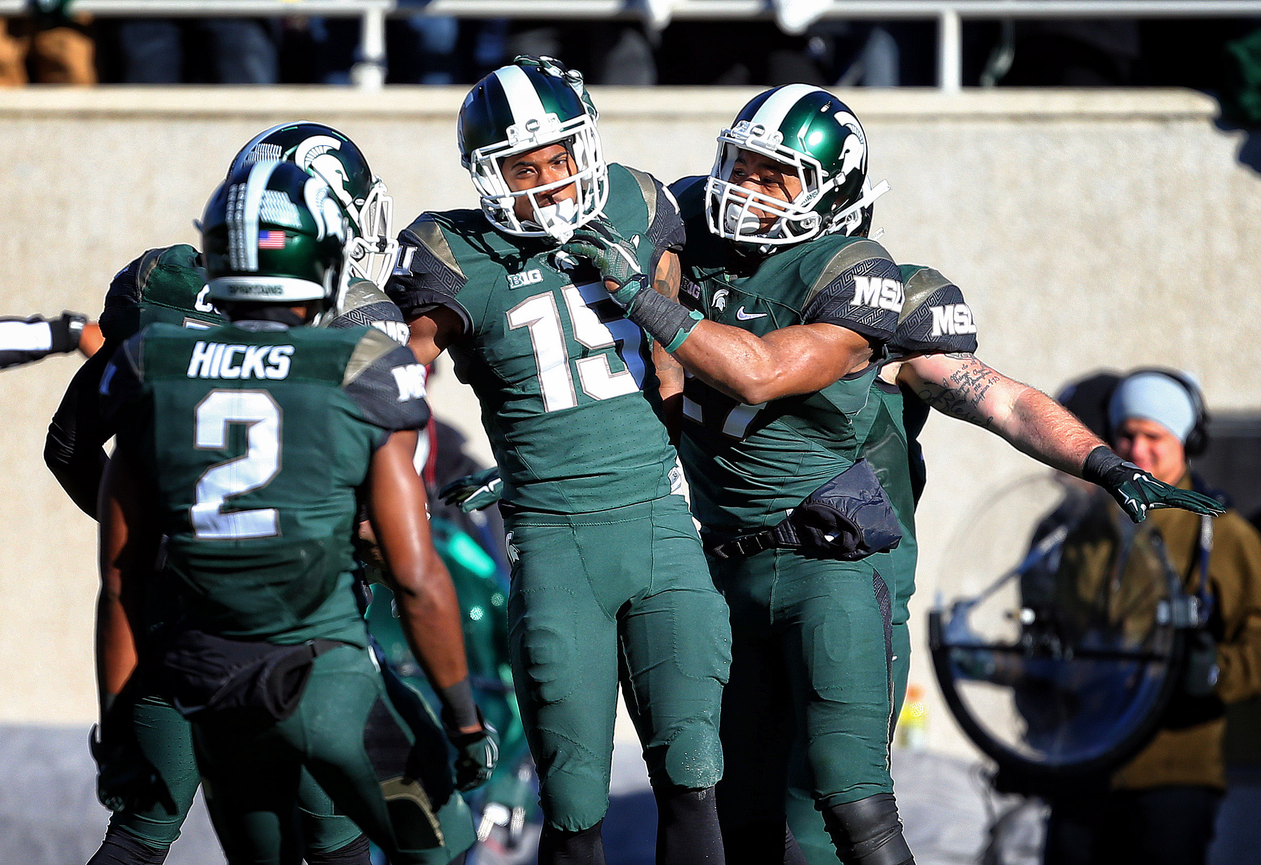 Nov 14, 2015; East Lansing, MI, USA; Michigan State Spartans cornerback Tyson Smith (15) and Michigan State Spartans cornerback Darian Hicks (2) celebrate defense stop during the 1st quarter of a game against the Maryland Terrapins at Spartan Stadium. Mandatory Credit: Mike Carter-USA TODAY Sports