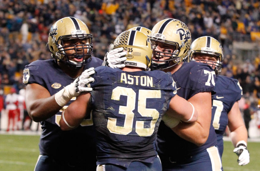 Nov 21, 2015; Pittsburgh, PA, USA; Pittsburgh Panthers offensive linemen Dorian Johnson (53) Brian O'Neill (70) celebrate with fullback George Aston (35) after Aston scored a four yard touchdown against the Louisville Cardinals during the second quarter at Heinz Field. PITT won 45-34. Mandatory Credit: Charles LeClaire-USA TODAY Sports