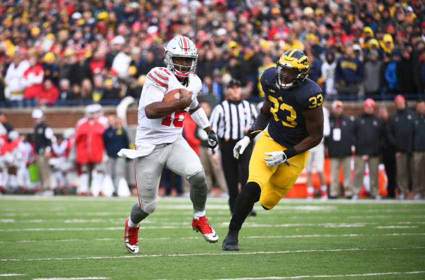 Nov 28, 2015; Ann Arbor, MI, USA; Ohio State Buckeyes quarterback J.T. Barrett (16) runs the ball against Michigan Wolverines defensive end Taco Charlton (33) during the game against the Michigan Wolverines at Michigan Stadium. Mandatory Credit: Tim Fuller-USA TODAY Sports