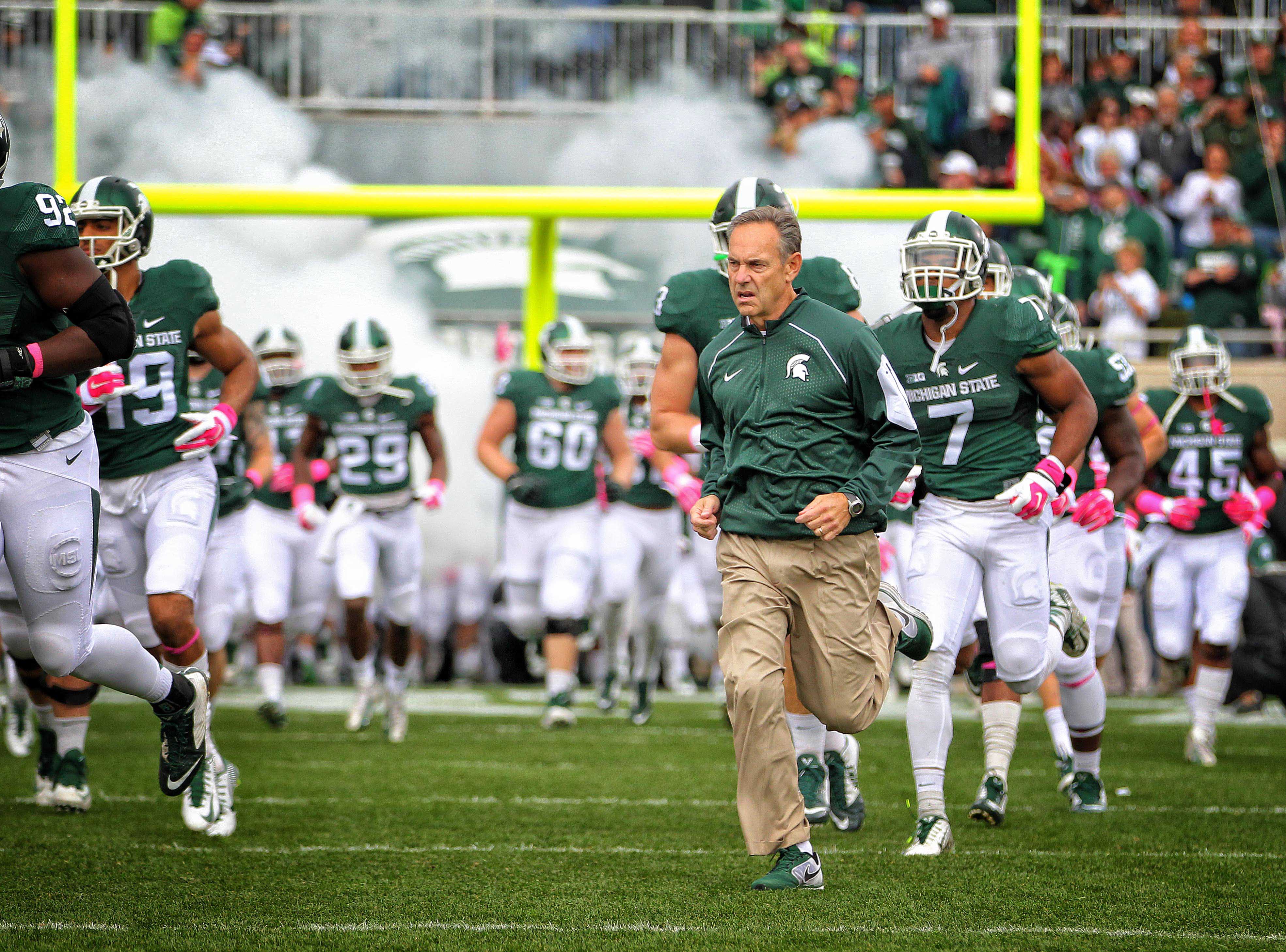 Oct 24, 2015; East Lansing, MI, USA; Michigan State Spartans head coach Mark Dantonio leads the Michigan State Spartans onto the field prior to a game against the Indiana Hoosiers at Spartan Stadium. Mandatory Credit: Mike Carter-USA TODAY Sports