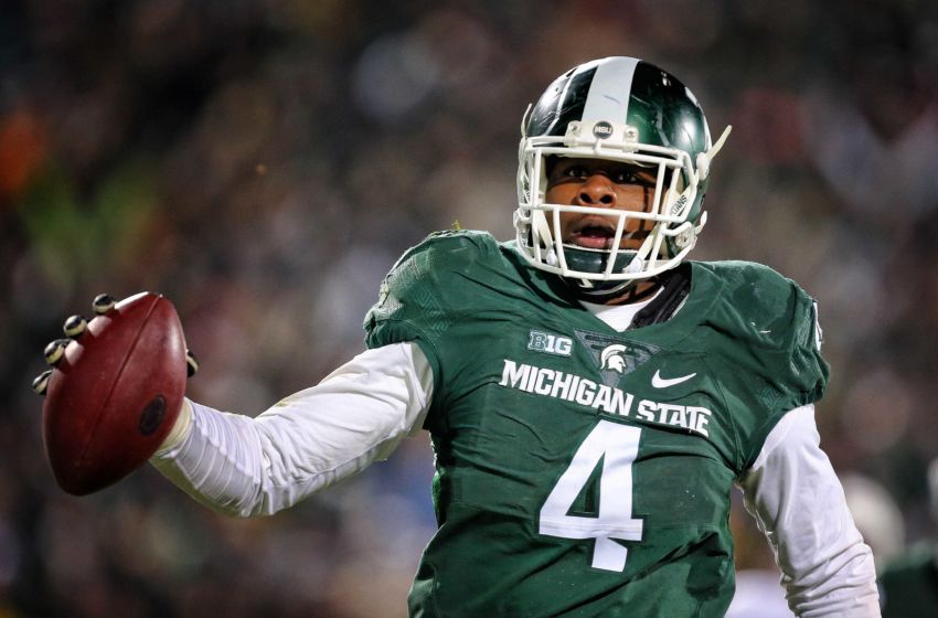 Nov 28, 2015; East Lansing, MI, USA; Michigan State Spartans defensive lineman Malik McDowell (4) scores on a pick 6 during the 2nd half of a game against the Penn State Nittany Lions at Spartan Stadium. Mandatory Credit: Mike Carter-USA TODAY Sports