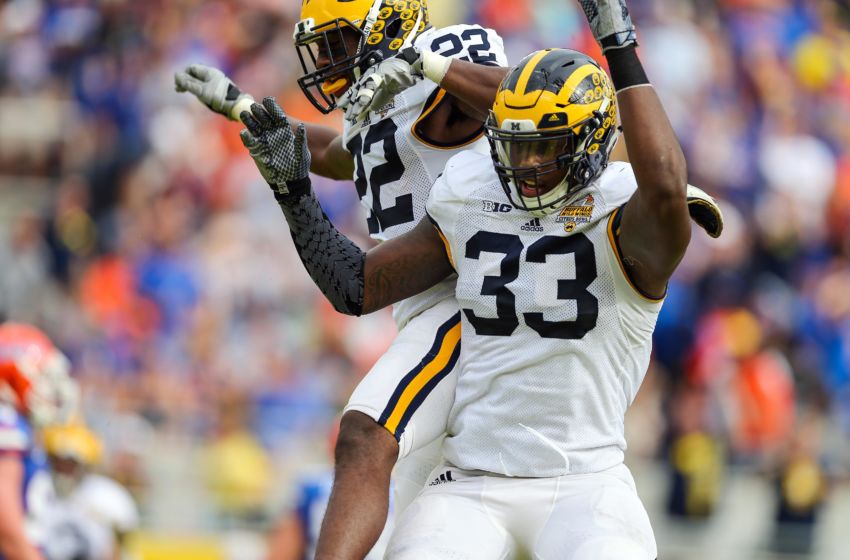 Jan 1, 2016; Orlando, FL, USA; Michigan Wolverines safety Jarrod Wilson (22) and defensive end Taco Charlton (33) celebrate his interception against the Florida Gators during the second quarter in the 2016 Citrus Bowl at Orlando Citrus Bowl Stadium. Mandatory Credit: Jim Dedmon-USA TODAY Sports