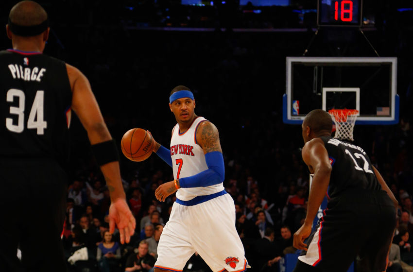 Jan 22, 2016; New York, NY, USA; New York Knicks forward Carmelo Anthony (7) handles the ball against Los Angeles Clippers forward Paul Pierce (34) and Los Angeles Clippers forward Luc Richard Mbah a Moute (12) during second half at Madison Square Garden. Mandatory Credit: Noah K. Murray-USA TODAY Sports