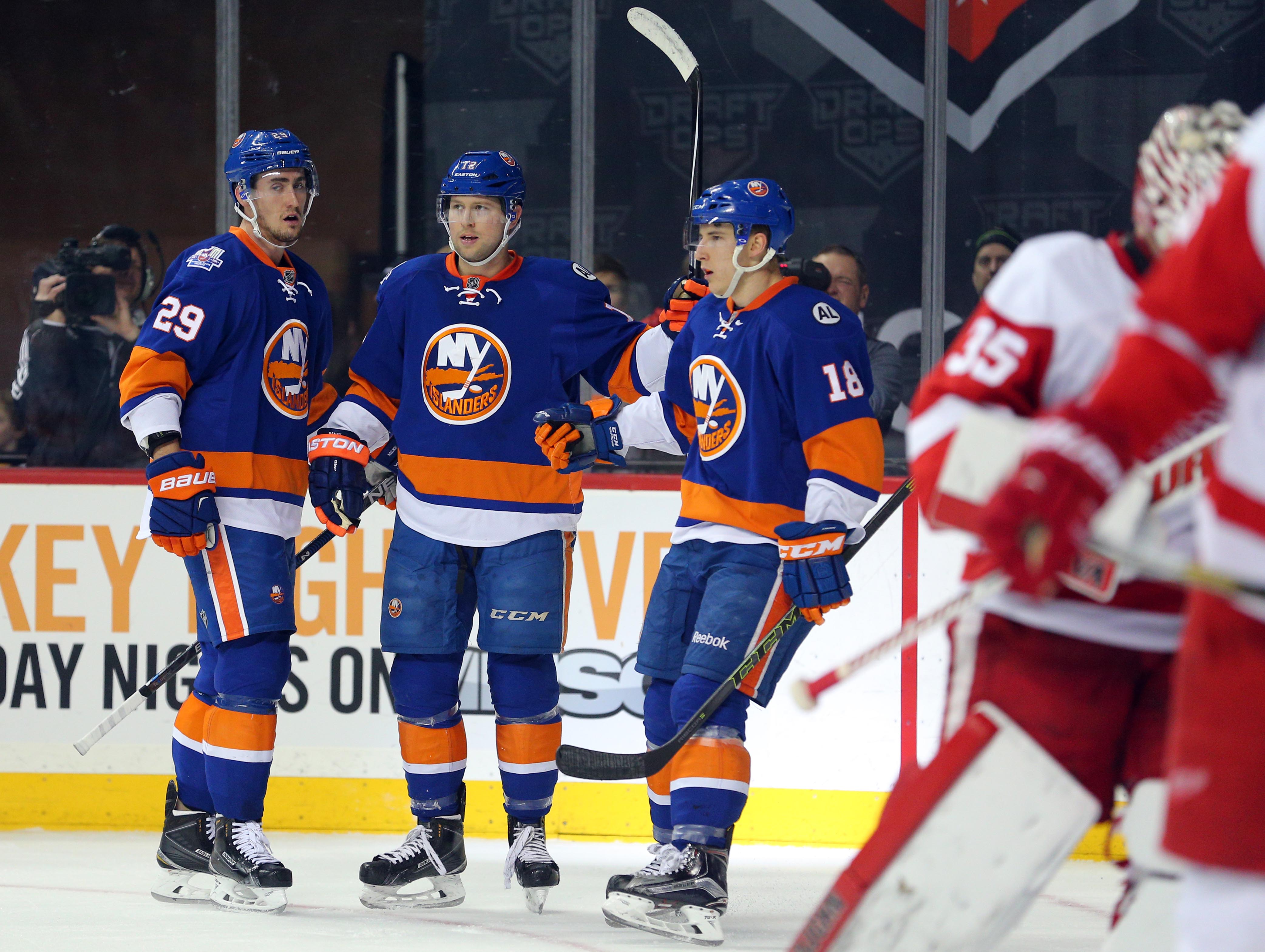 Feb 15, 2016; Brooklyn, NY, USA; New York Islanders left wing Josh Bailey (12) celebrates his goal against the Detroit Red Wings with teammates center Brock Nelson (29) and center Ryan Strome (18) during the second period at Barclays Center. Mandatory Credit: Brad Penner-USA TODAY Sports