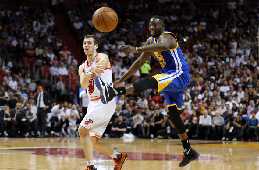 Feb 24, 2016; Miami, FL, USA; Miami Heat guard Goran Dragic (7) passes the ball as Golden State Warriors forward Draymond Green (23) attempts to kick the ball during the second half at American Airlines Arena. Mandatory Credit: Steve Mitchell-USA TODAY Sports