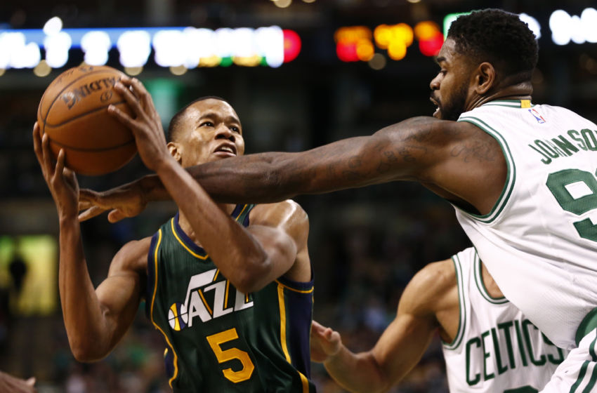 Feb 29, 2016; Boston, MA, USA; Utah Jazz guard Rodney Hood (5) is fouled by Boston Celtics forward Amir Johnson (right) during the second half at TD Garden. Mandatory Credit: Mark L. Baer-USA TODAY Sports