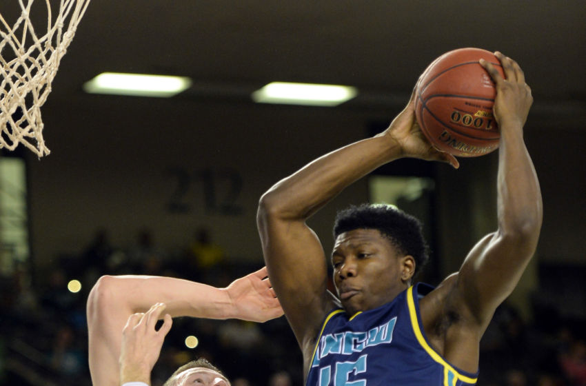Mar 7, 2016; Baltimore, MD, USA; North Carolina-Wilmington Seahawks forward Devontae Cacok (15) rebounds over Hofstra Pride forward Rokas Gustys (11) during the first half of the CAA conference tournament finals at Royal Farms Arena. Mandatory Credit: Tommy Gilligan-USA TODAY Sports