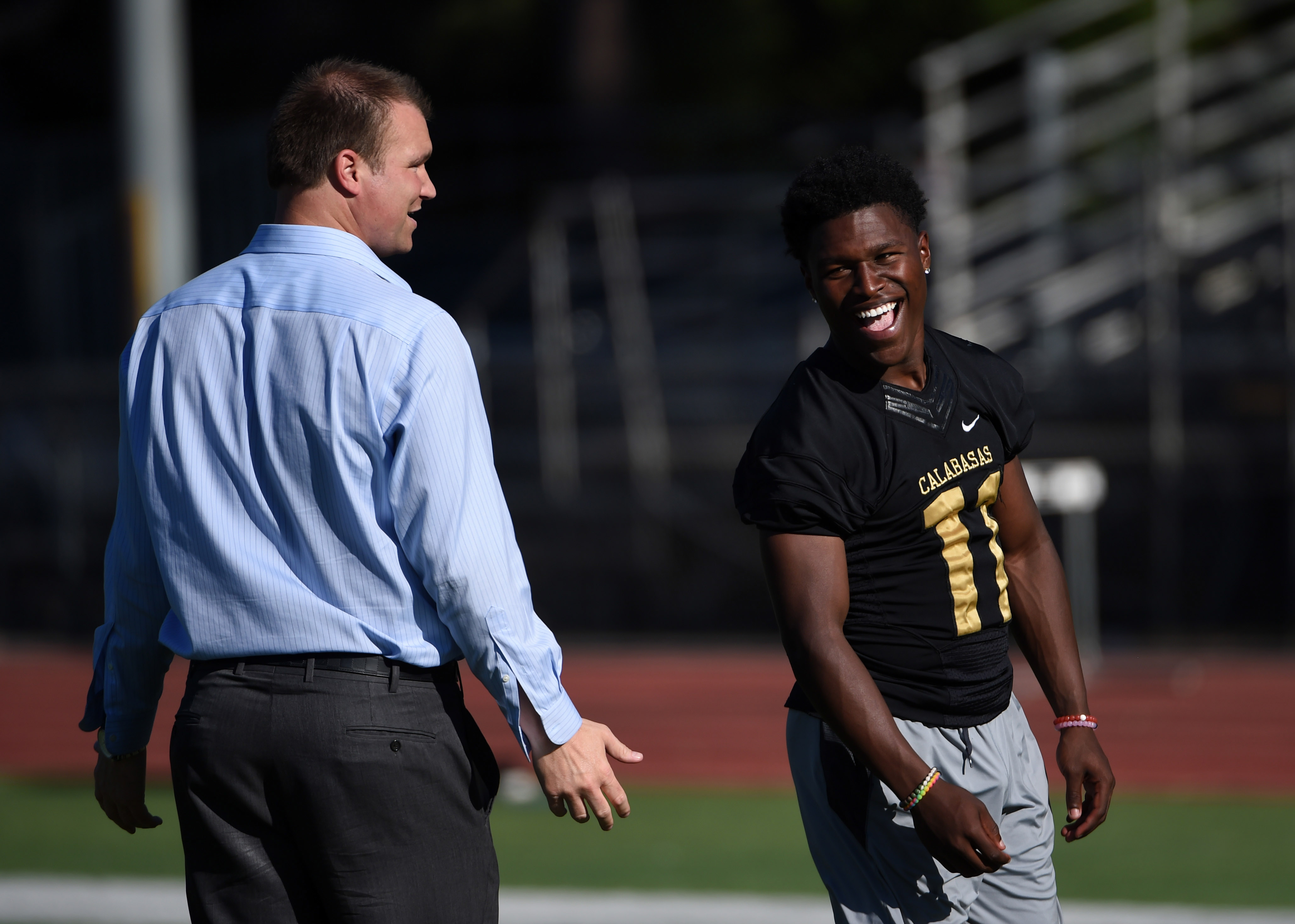 Apr 12, 2016; Calabasas, CA, USA; Calabasas High Coyotes coach Casey Clausen (left) talks with defensive back Darnay Holmes (11) during practice. Mandatory Credit: Kirby Lee-USA TODAY Sports