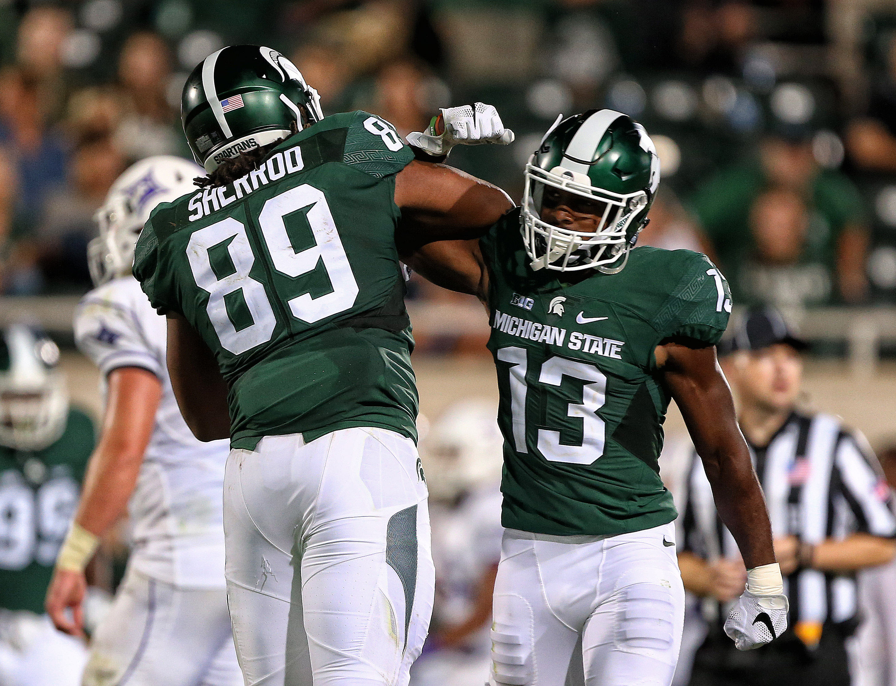 Sep 2, 2016; East Lansing, MI, USA; Michigan State Spartans defensive end Gabe Sherrod (89) celebrates with cornerback Vayante Copeland (13) after a defense stop during the second half against the Furman Paladins at Spartan Stadium. Mandatory Credit: Mike Carter-USA TODAY Sports