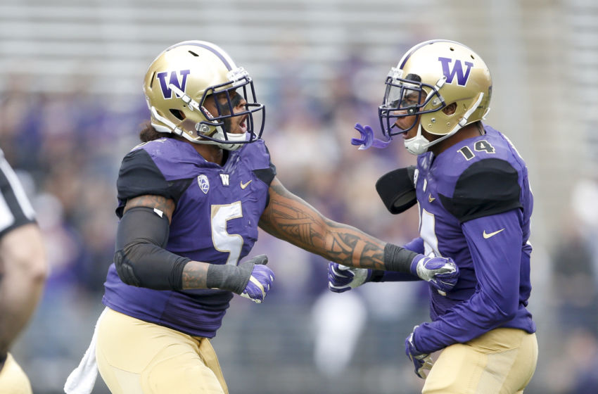 Sep 3, 2016; Seattle, WA, USA; Washington Huskies linebacker Joe Mathis (5) celebrates a tackle with defensive back Jojo McIntosh (14) against the Rutgers Scarlet Knights during the first quarter at Husky Stadium. Washington won 48-13. Mandatory Credit: Jennifer Buchanan-USA TODAY Sports