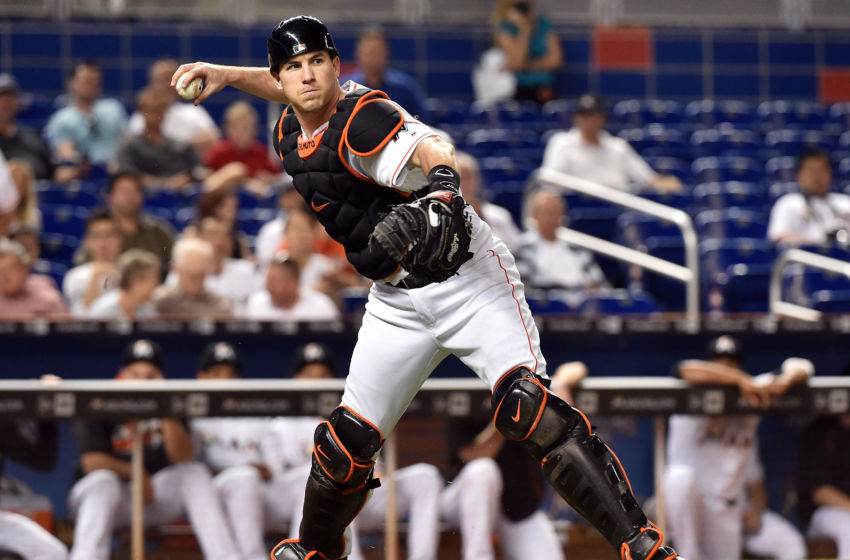 Sep 19, 2016; Miami, FL, USA; Miami Marlins catcher J.T. Realmuto (11) throws out Washington Nationals right fielder Chris Heisey (not pictured) at first base during the second inning at Marlins Park. Mandatory Credit: Steve Mitchell-USA TODAY Sports