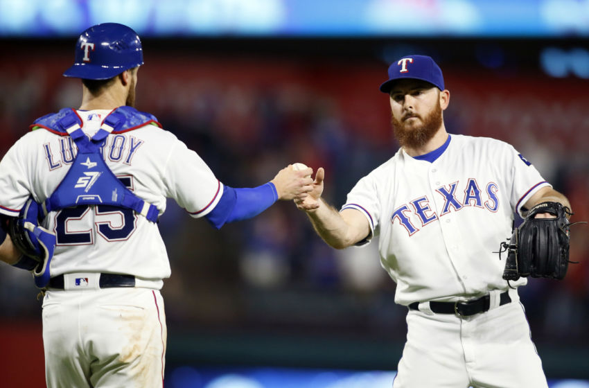 Sep 27, 2016; Arlington, TX, USA; Texas Rangers catcher Jonathan Lucroy (25) hands the ball to relief pitcher Sam Dyson (47) after he struck out Milwaukee Brewers right fielder Domingo Santana (not pictured) to end the game at Globe Life Park in Arlington. Texas won 6-4. Mandatory Credit: Tim Heitman-USA TODAY Sports
