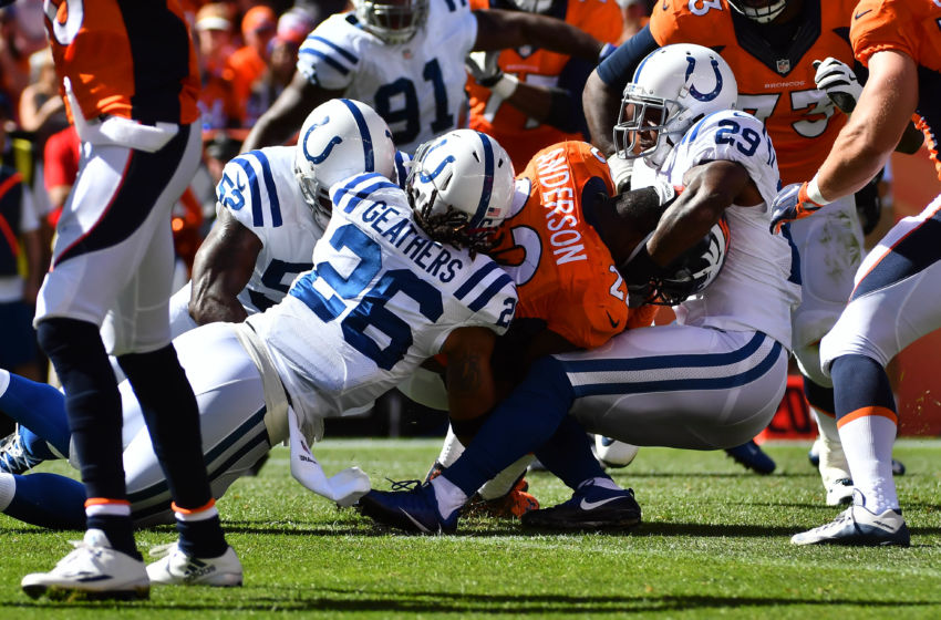 Sep 18, 2016; Denver, CO, USA; Indianapolis Colts strong safety Mike Adams (29) and inside linebacker D'Qwell Jackson (52) and strong safety Clayton Geathers (26) tackle Denver Broncos running back C.J. Anderson (22) in the first half at Sports Authority Field at Mile High. Mandatory Credit: Ron Chenoy-USA TODAY Sports