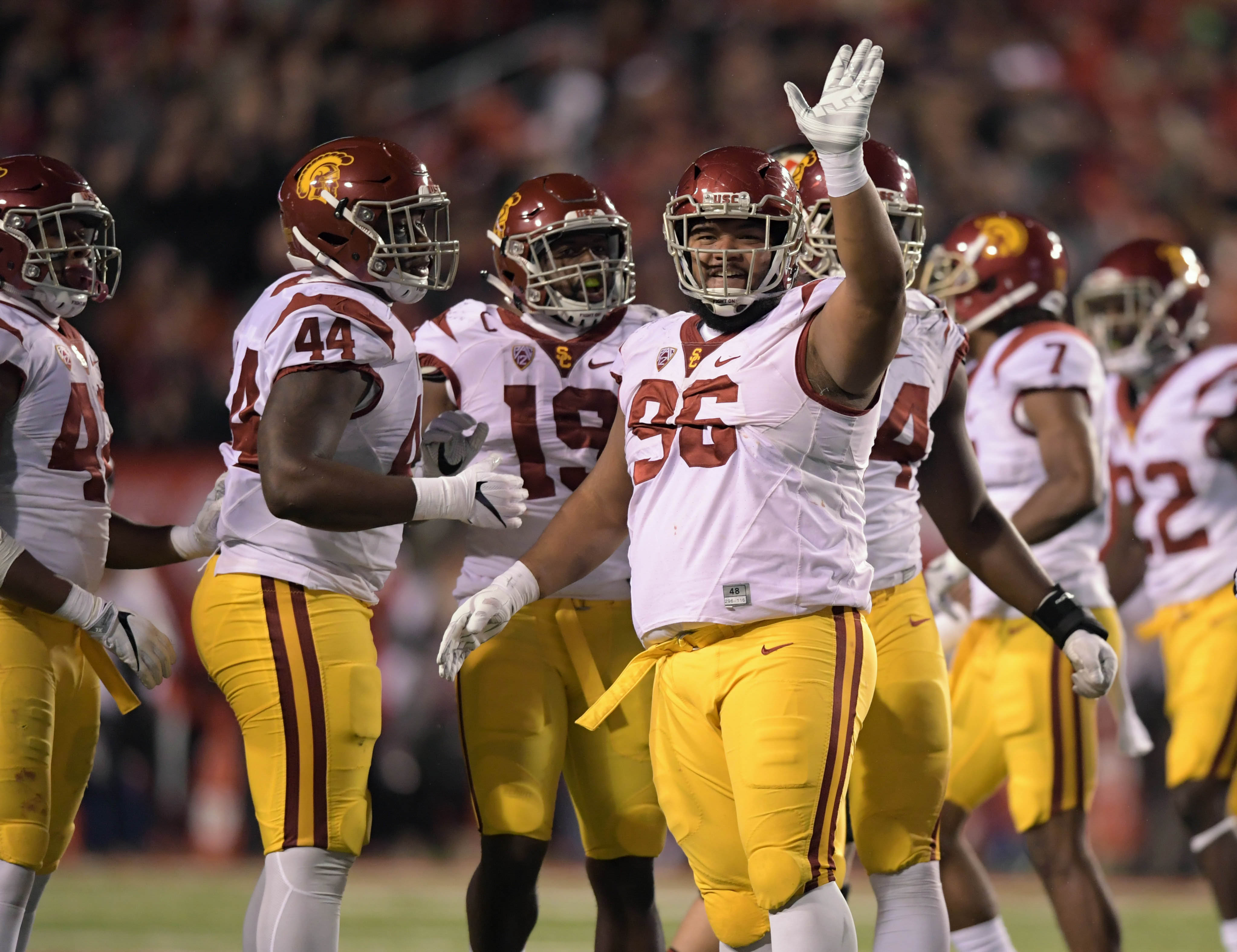 Sep 23, 2016; Salt Lake City, UT, USA; USC Trojans defensive tackle Stevie Tu'ikolovatu (96) celebrates with defensive tackle Malik Dorton (44) and linebacker Michael Hutchings (19) during a NCAA football game at Rice-Eccles Stadium. Utah defeated USC 31-27. Mandatory Credit: Kirby Lee-USA TODAY Sports