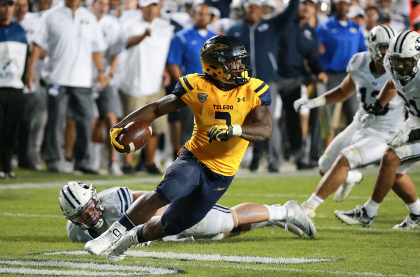 Sep 30, 2016; Provo, UT, USA; Toledo Rockets running back Kareem Hunt (3) tries to find a way around the Brigham Young Cougars defense during the fourth quarter at Lavell Edwards Stadium. Brigham Young won 55-53. Mandatory Credit: Chris Nicoll-USA TODAY Sports