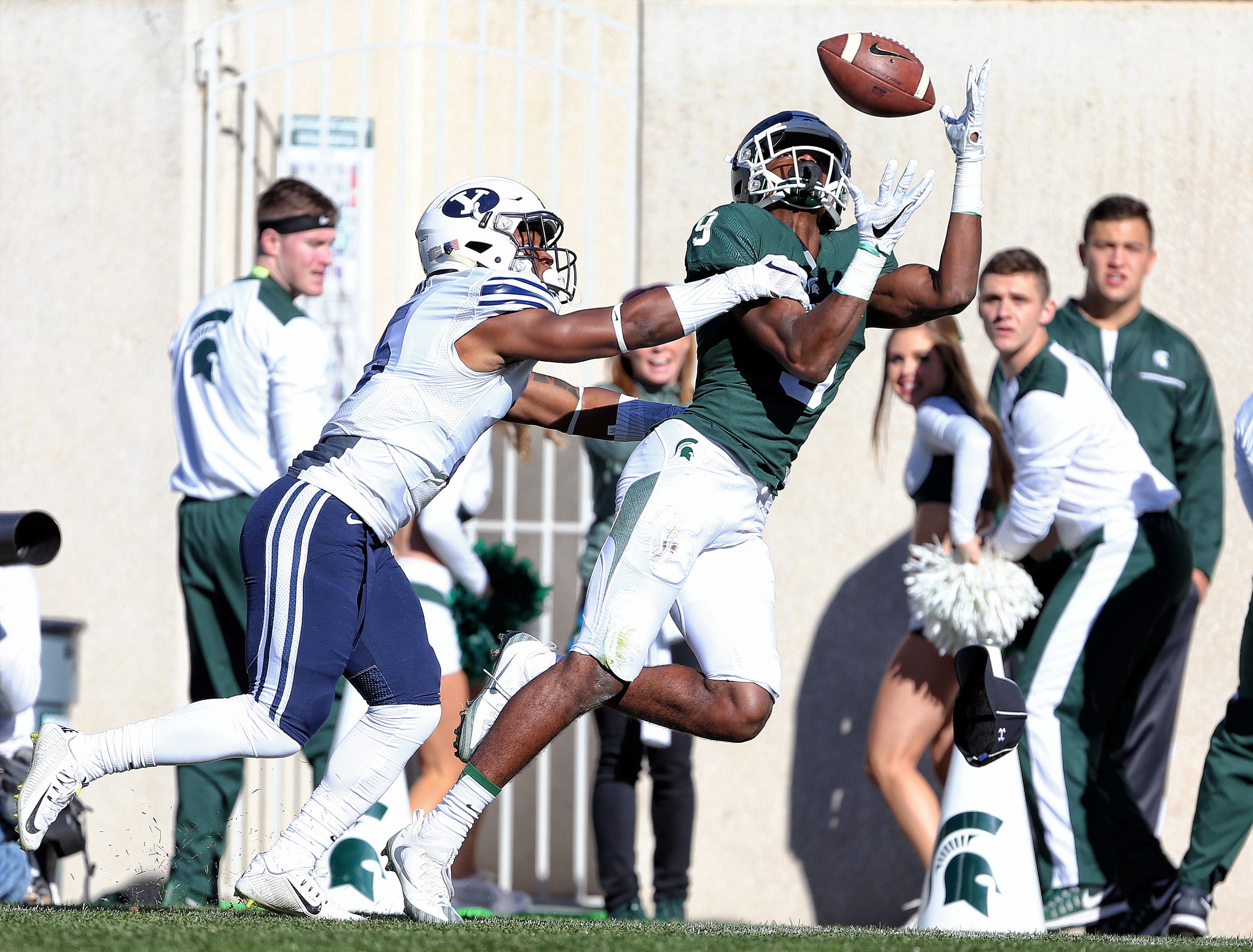 Oct 8, 2016; East Lansing, MI, USA; Michigan State Spartans wide receiver Donnie Corley (9) attempts to make a catch against Brigham Young Cougars defensive back Dayan Lake (5) during the 1st quarter of a game at Spartan Stadium. Mandatory Credit: Mike Carter-USA TODAY Sports
