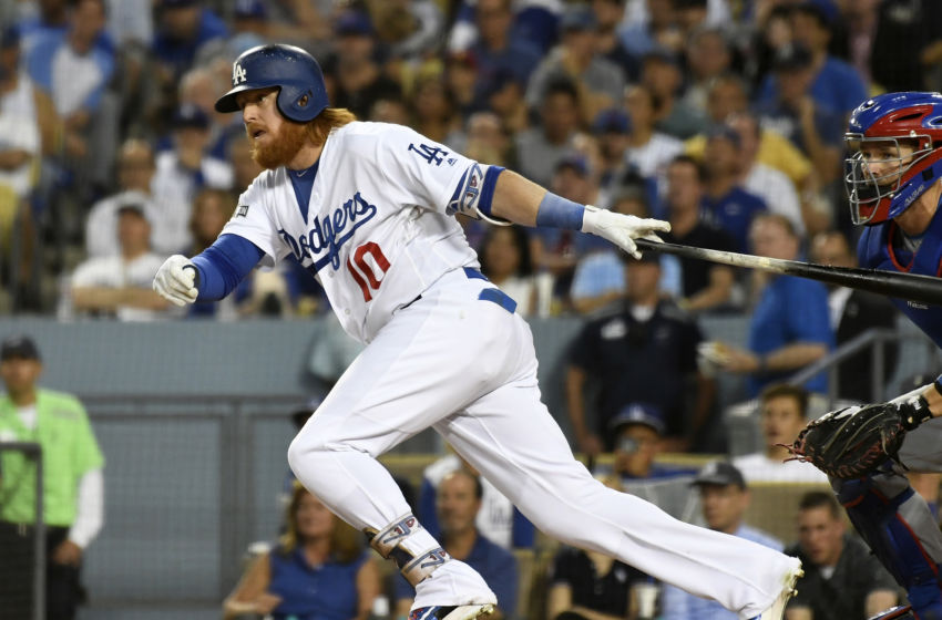 Oct 20, 2016; Los Angeles, CA, USA; Los Angeles Dodgers third baseman Justin Turner (10) connects for a single in the third inning against the Chicago Cubs in game five of the 2016 NLCS playoff baseball series against the Los Angeles Dodgers at Dodger Stadium. Mandatory Credit: Richard Mackson-USA TODAY Sports