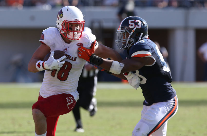 Oct 29, 2016; Charlottesville, VA, USA; Louisville Cardinals tight end Cole Hikutini (18) runs with the ball as Virginia Cavaliers linebacker Micah Kiser (53) chases in the fourth quarter at Scott Stadium. The Cardinals won 32-25. Mandatory Credit: Geoff Burke-USA TODAY Sports
