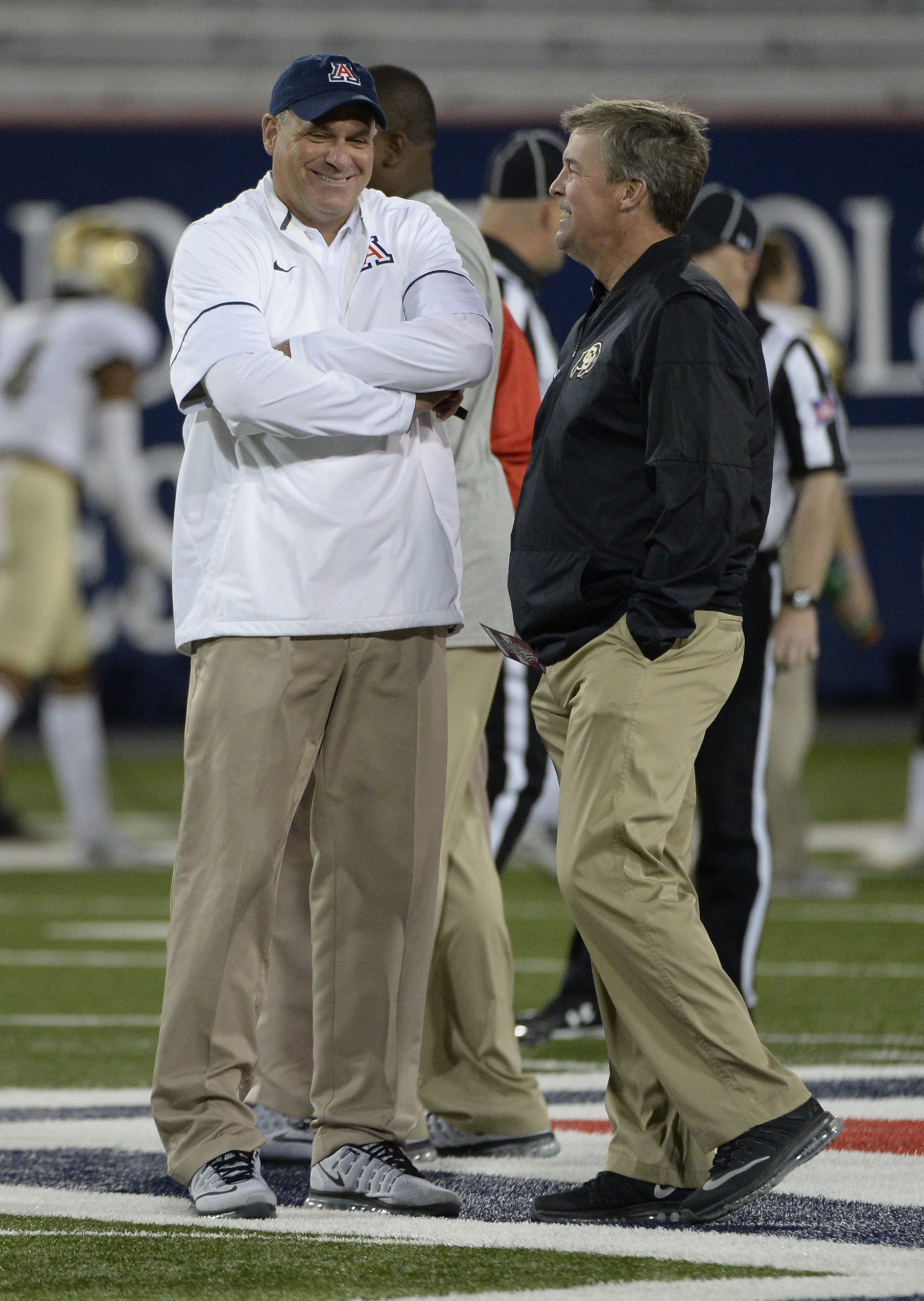 Nov 12, 2016; Tucson, AZ, USA; Arizona Wildcats head coach Rich Rodriguez (left) and Colorado Buffaloes head coach Mike MacIntyre talk during warm ups at Arizona Stadium. Mandatory Credit: Casey Sapio-USA TODAY Sports