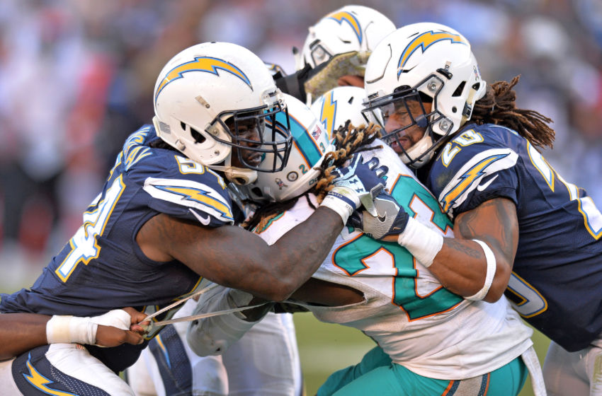 Nov 13, 2016; San Diego, CA, USA; Miami Dolphins running back Jay Ajayi (23) is wrapped up by San Diego Chargers outside linebacker Melvin Ingram (54) and San Diego Chargers free safety Dwight Lowery (20) during the fourth quarter at Qualcomm Stadium. Mandatory Credit: Jake Roth-USA TODAY Sports