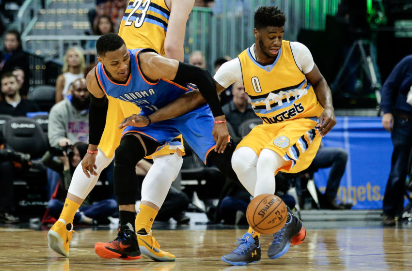 Nov 25, 2016; Denver, CO, USA; Oklahoma City Thunder guard Russell Westbrook (0) and Denver Nuggets guard Emmanuel Mudiay (0) battle for the ball in the third quarter at the Pepsi Center. The Thunder won 132-129. Mandatory Credit: Isaiah J. Downing-USA TODAY Sports