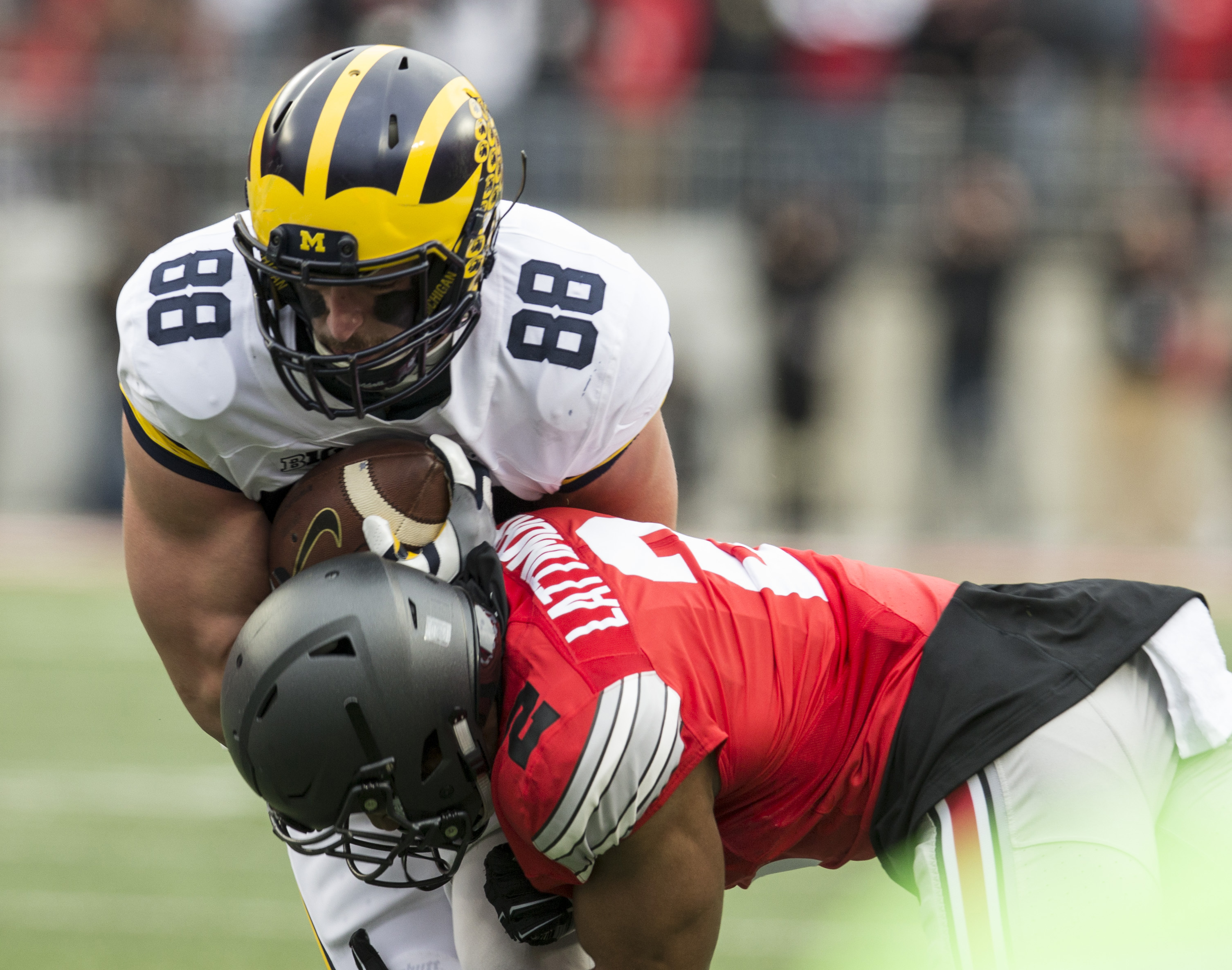 Nov 26, 2016; Columbus, OH, USA; Michigan Wolverines tight end Jake Butt (88) is tackled by Ohio State Buckeyes cornerback Marshon Lattimore (2) in the second quarter at Ohio Stadium. Mandatory Credit: Greg Bartram-USA TODAY Sports