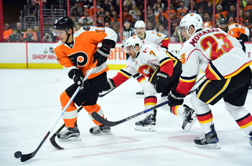 Nov 27, 2016; Philadelphia, PA, USA; Philadelphia Flyers center Travis Konecny (11) carries the puck against defenseman TJ Brodie (7) and Calgary Flames center Sean Monahan (23) during the second period at Wells Fargo Center. Mandatory Credit: Eric Hartline-USA TODAY Sports