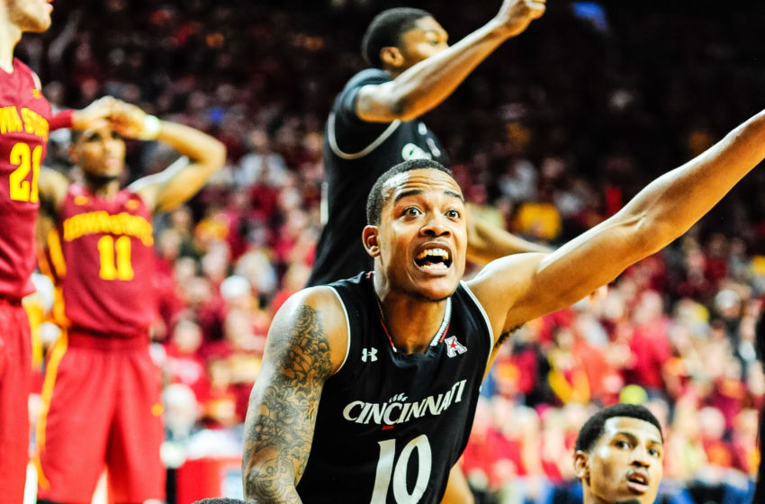 Dec 1, 2016; Ames, IA, USA; Cincinnati Bearcats forward Gary Clark (bottom) and guard Troy Caupain (10) fight for a loose ball on the final play during overtime against the Iowa State Cyclones at James H. Hilton Coliseum. Cincinnati won 55-54. Mandatory Credit: Jeffrey Becker-USA TODAY Sports