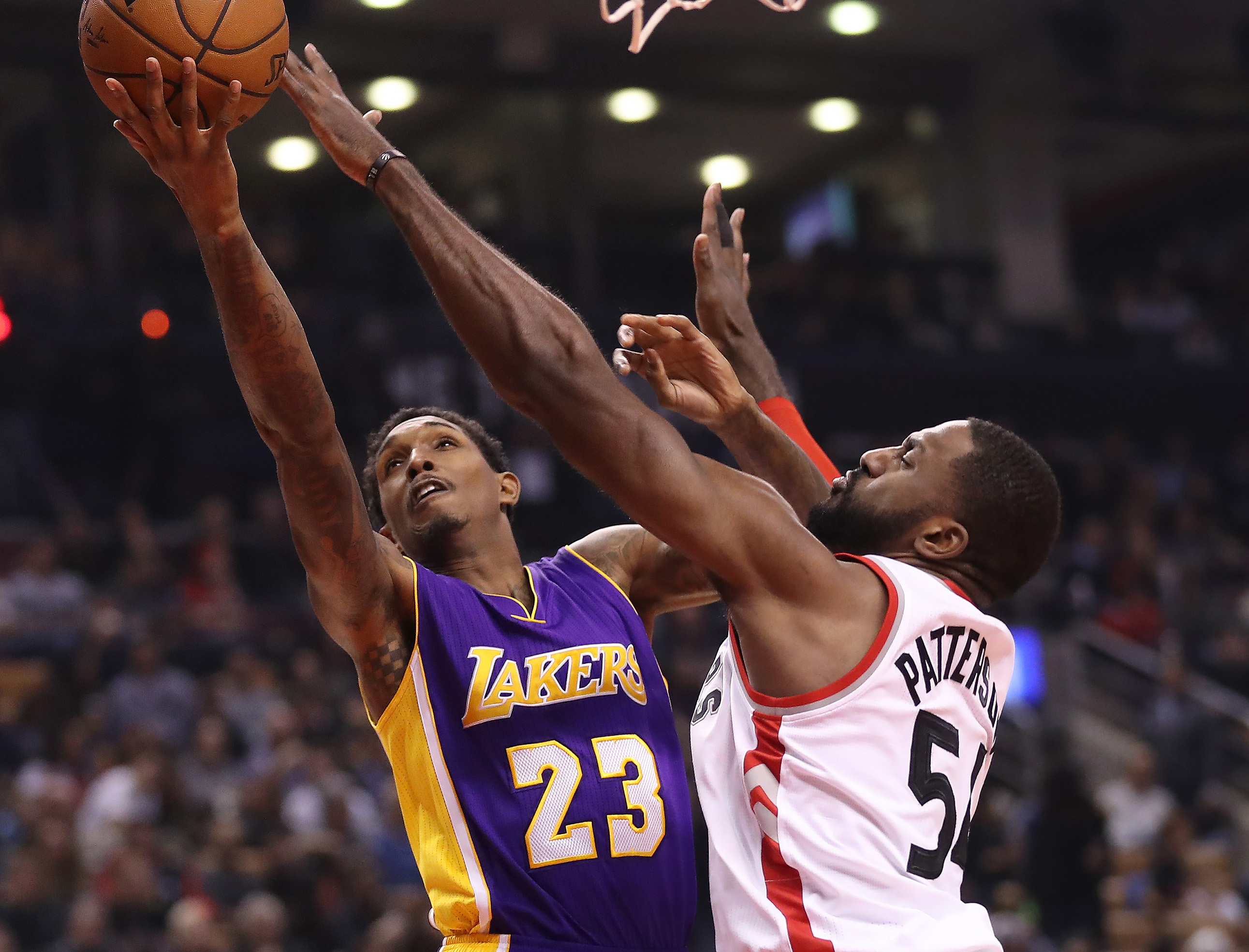 Dec 2, 2016; Toronto, Ontario, CAN; Los Angeles Lakers point guard Lou Williams (23) goes up to score against Toronto Raptors forward Patrick Patterson (54) at Air Canada Centre. Mandatory Credit: Tom Szczerbowski-USA TODAY Sports